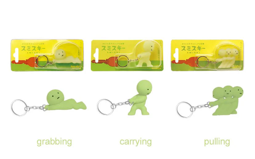 Smiski Keychains in packaging, featuring tiny glowing creatures designed to protect keys and hide in small spaces.
