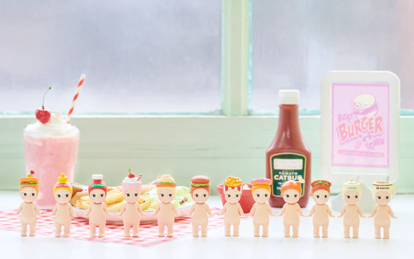 Sonny Angel - Snack Series figurines with food-themed hats amid an American diner setup, featuring burgers, milkshake, and a Best Burger in Town sign.