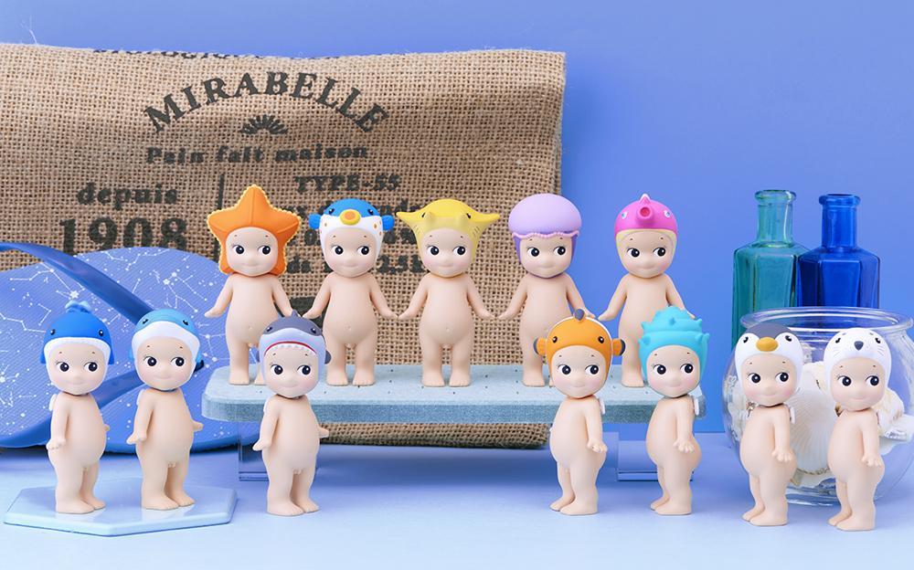 Sonny Angel - Marine blind box figures: small dolls and toys in various designs, including animals hats and a blue bottle.