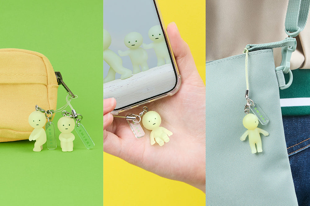 SMISKI Strap Accessories Series 1 keychain, featuring a small face charm, showcased on a yellow bag. A unique fashion accessory from Strangecat Toys.