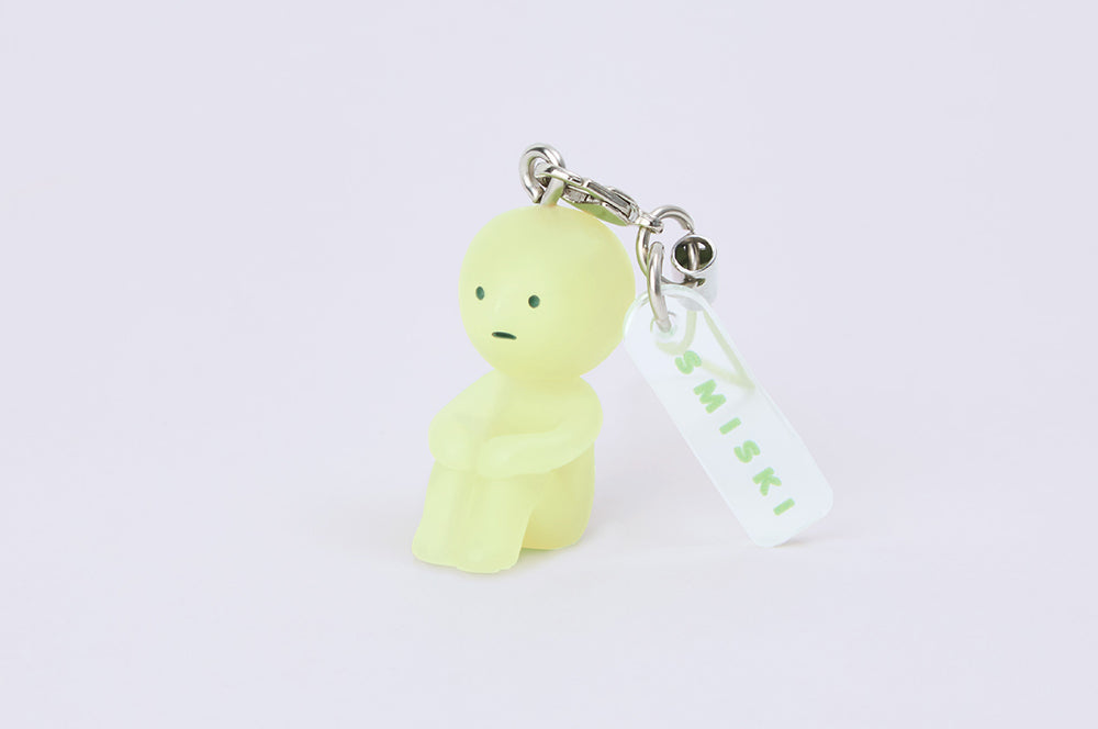 SMISKI Strap Accessories Series 1: A close-up of a keychain featuring a mini yellow SMISKI figure with a sad face, ideal for collectors and fans.