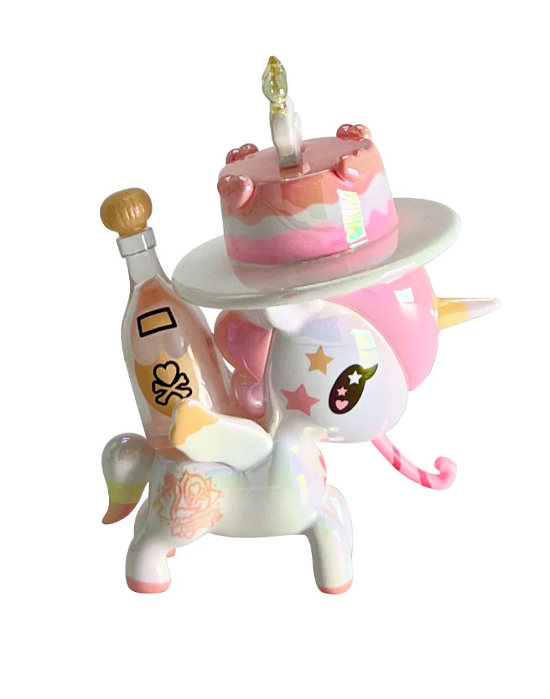 Tokidoki 20th Anniversary Blind Box: Pastel vinyl unicorn figurine with cake, drink, heart and star motifs, wings, and horn, celebrating two decades of tokidoki art.