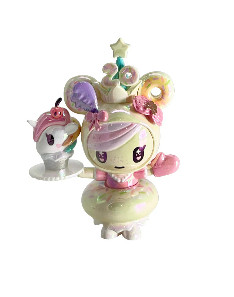 tokidoki 20th Anniversary Blind Box featuring a donut-themed character with a frosted dress, crown, and unicorn dessert, celebrating kawaii culture.