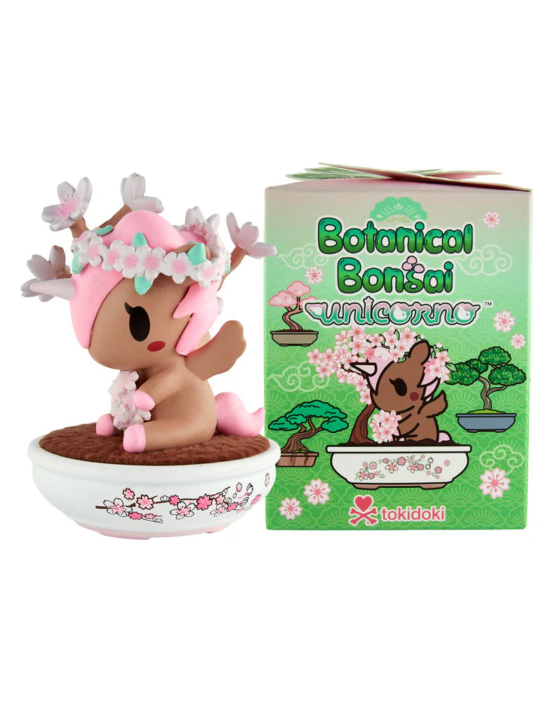 Tokidoki Botanical Bonsai Unicorno collectible, featuring a cherry blossom-adorned unicorno in a bonsai pot, with its matching illustrated box in Tokidoki's kawaii style.
