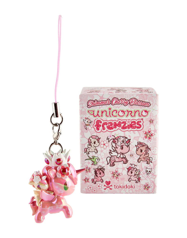 Shimmer Cherry Blossom Unicorno Frenzies charm with cherry blossom details and pink strap, alongside its decorative pink box featuring tokidoki branding.