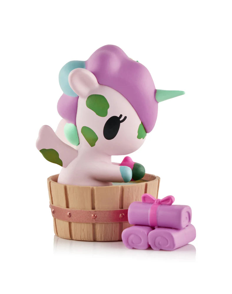 Spa Day Unicorno Blind Box - Preorder features a pastel unicorn figurine in a wooden tub with lavender towels, part of a kawaii collectible series.