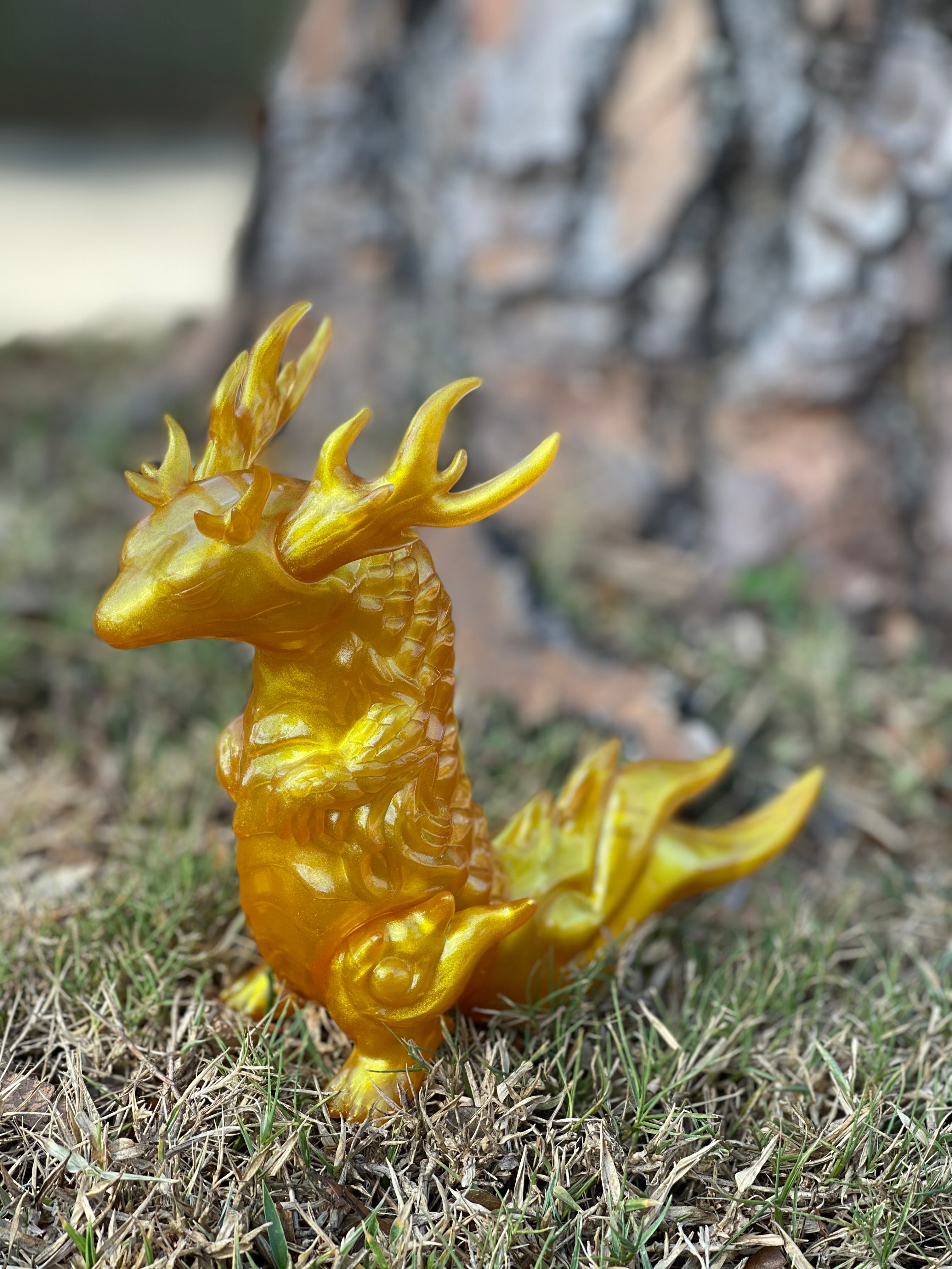 Japanese Soft Vinyl statue of a yellow dragon in grass, designed by Kashi, 15cm tall, 18cm from nose to tail.