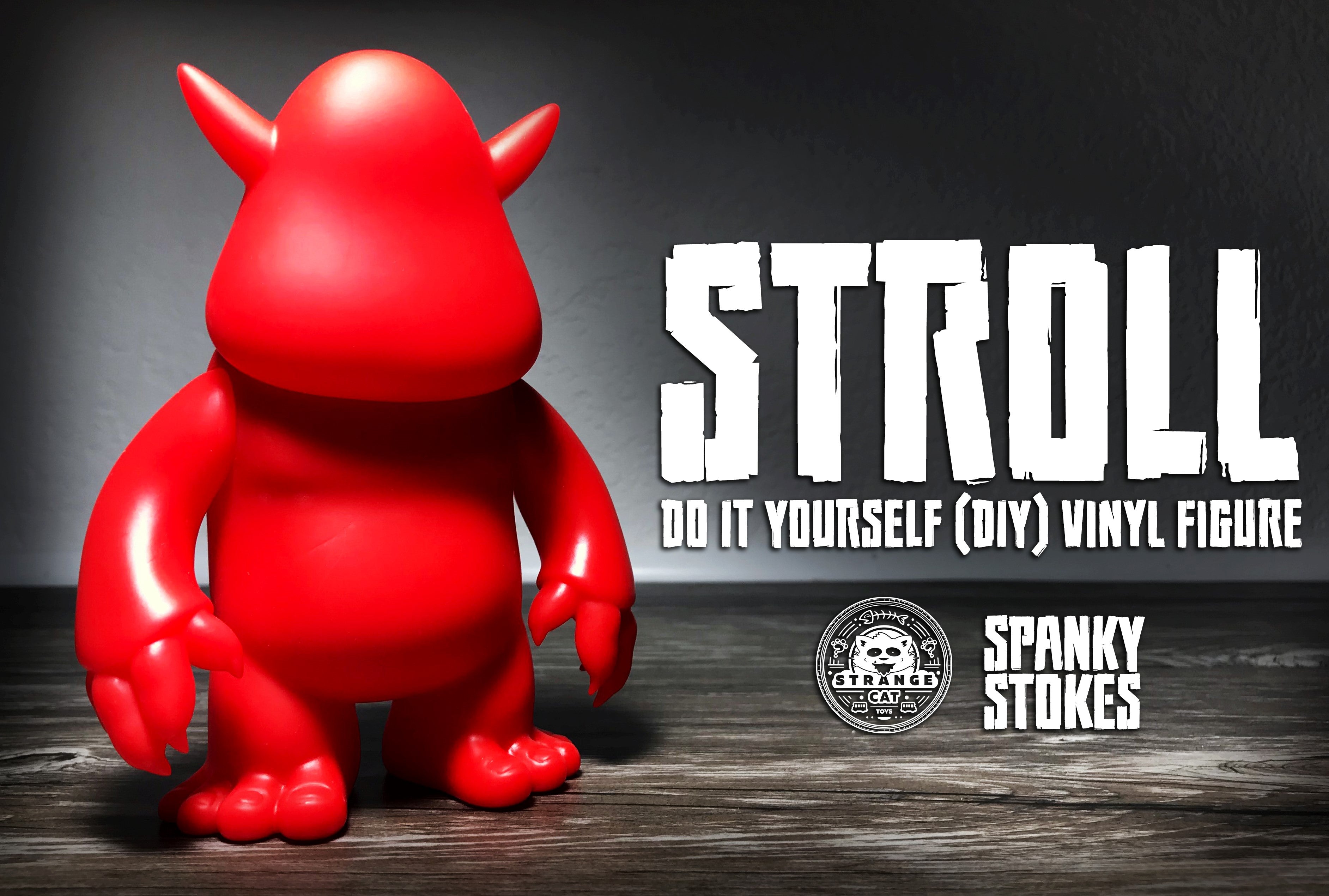 Stroll DIY Red Vinyl toy with horns and logo of a cat, close-up details included.